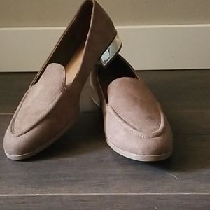 Tan loafer style shoes.